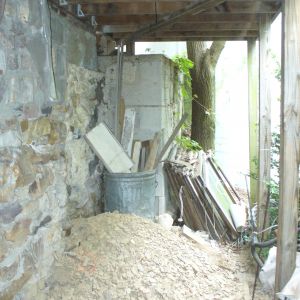 BEFORE: under our back deck. That pile of dirt/shale is what a groundhog dug out as he burrowed under the house!