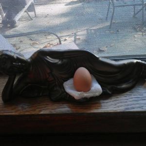 *
Picture of the first egg from my flock! Buddha watches safely over the egg lol
