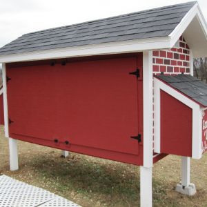 Back doors on.  Did not care to paint them with the brick pattern since they back up to the woods.  Wont be seen.  Put up a make shift soffit for the underside of the roof overhang using OSB and painted it white.