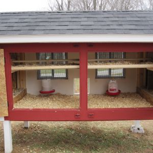 Inside of coop shows the roosting trays which are removable.  I have since then, removed one of them (hung the food and water under the other one to lessen the chance of it getting dirty) and added two 2x2 across the top of the coop.  Found that they kept roosting on the bar I had the food hung on instead of the roosting trays.  I just gave them two long bars across the top.  They like that better.