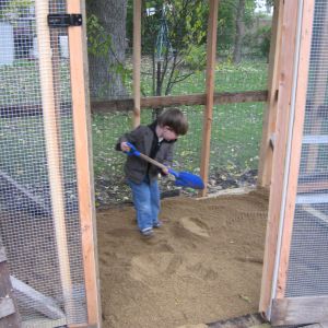 Simon helping add sand to the run
