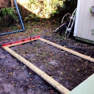 The bricks and pressure treated wood are FINALLY leveled out and ready for the run walls to be raised upon the base.