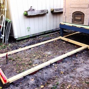The bricks and pressure treated wood are FINALLY leveled out and ready for the run walls to be raised upon the base.