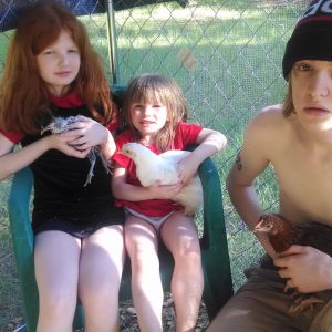 Christopher holding Brownie, Aryanna holding Willis and Mckenzie holding her Spitz named Moe.