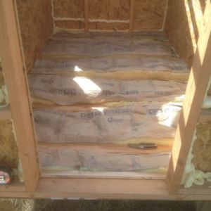 Fiberglass insulation installed in the floor of the coop.