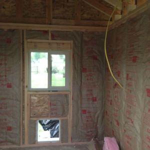 We chose to insulate, not as much to keep warm in the winter, but to keep cool in the summer.  So far, I am SO glad we did this.  It has been ridiculously hot the past few weeks, and the coop is wonderfully ventilated and stays at a very nice temp.  You can also see, we are adding electrical wiring for later use.  We are going to eventually add a solar panel- just for light, and maybe a method of heating their waterer (I have read about using a light bulb inside a cinder block and setting water container on top- but that is something for us to learn this winter!).