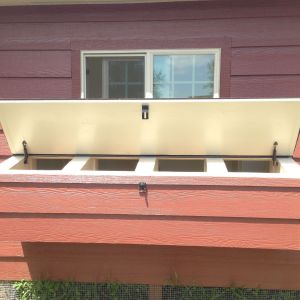 Nesting boxes prop open.  Had a difficult time making this part water tight.  It kept leaking through the hinge.  Finally achieved it by laying some rubber over the hinge, then laying shingles over it and trim board over other side.  I think it looks even better that way because the hinge less noticeable now too!  You might be able to see this in the next pic where lid is closed.