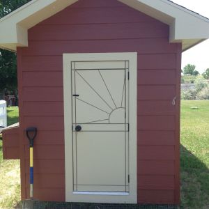 We made the door, as it is smaller than a standard sized door.  This allowed us to make a faux dutch door and add a little flare by cutting the sun into it.