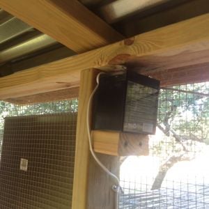 Battery on shelf for Pullet Shut door, it it charged by a solar panel on the roof