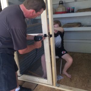 We designed and built our screen door. My husband and 13-year old daughter are putting it up.