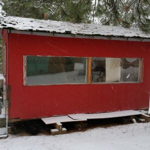 8x16 insulated coop, with a ramp and  an auto chicken door (Ador).  I threw a popped air mattress on top of the ramp to keep it dry, the ramp leads to a covered run. I keep the run open so that they can go outside, they have a 1/2 acre fenced in to free range. There is a coop cam inside, I can check on them via my computer from the house anytime 24/7.  It's  Finished on the inside, but not finished on the outside. It's a work in progress.