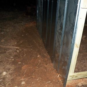 We buried the sheet metal a few inches underground to help deter critters from getting in.