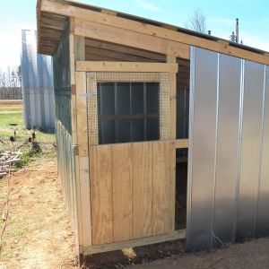 The door hung up and the fourth wall almost finished.