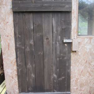 Plank door with draw latch on the new Tudor style chick house.