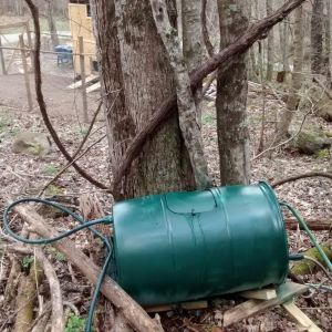 I have an elevated creek below on the right out of frame.  This my water barrel I feed from that creek and connected to water hose i now have water onsite at my chicken house.