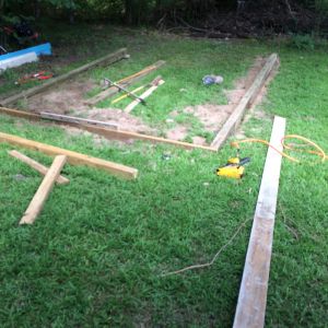 Here we have the 4'x6 pressure treated beams and PT 2x6's for the ends. I buried it in the ground to get it level as well as help keep critters from getting under it.