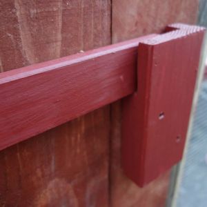 Big bar-type latch that secures the big double coop doors. Very secure and low-cost to make.