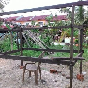 I'm using left over woods after house renovation. As its been there  too long under the sun, some of the woods I'm using are mostly bent. I've got no choice & $$ ;) , so have to utilize whatever  is there. Paint it with wood stain.  Setting up the main coop frame on uneven ground.  Using bricks to level it up.