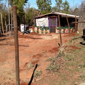Initial progress report.  Holes dug, setting posts in concrete.