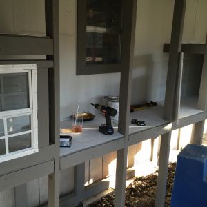 We also ended up ordering a pair of 12"x18" windows from Amazon.  These windows provided the perfect amount of light and ventilation for the center portions of the coop.  We also cut small 4"x12" windows out along the top of the nesting area walls, and then covered them with hardware clloth and framed them in as well.