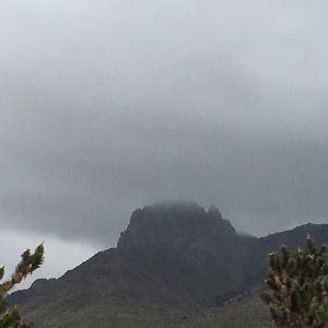 Mt. Mitten, through dark clouds, as seen from Akerta Acres in NW Arizona.