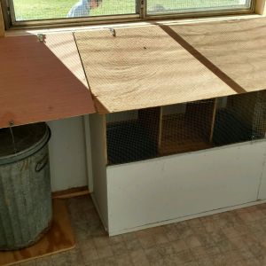 I put a slanted "roof" over the nesting boxes to deter roosting on the top( more advice from this site). They hook up for me to gather the eggs. I also enclosed the front of the garbage can area with  a door that slides in and out. Now the chicks can not get in there. I keep the feed and a bag of shavings in there. It is convenient for me. I have trays in the nesting boxes for easy cleaning. Right now I have the nesting boxes blocked off with wire(some more advise from this site). When the chickens are old enough to start laying eggs I will take the wire off.