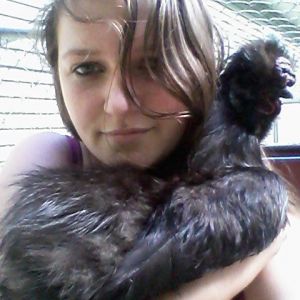 Me and the first  I got, Clyde. Sweetest rooster I've ever met I even got my senior photos taken with him