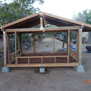 I started my first chicken coop this way. I over-extended the length of the coop to provide shed for the nest boxes  during rainy days.