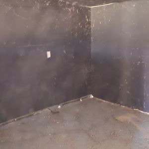 inside the shed after clearing out dead rat carcasses and trash left my previous owners....black painted walls!  that has got to go.  Needs a new paint job