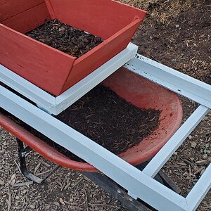 Compost sifter mounted on the wheelbarrow