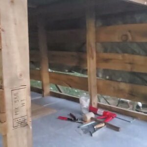 Laying new floor in the duck house and started to rain