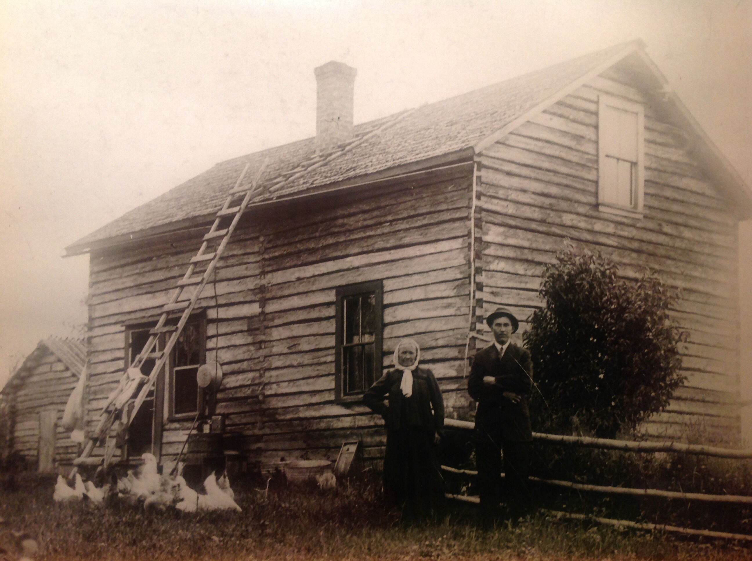 1916 Near Cook, MN. Anttie and Sophie Rankila. Earliest family picture with chickens. Funny how a couple chickens look like white blurs because they can't sit still for the long exposure time. Not at all like the stoic Finns who could hold a grimaced face for hours. House built by Juha Tekkoniemi 1892.
