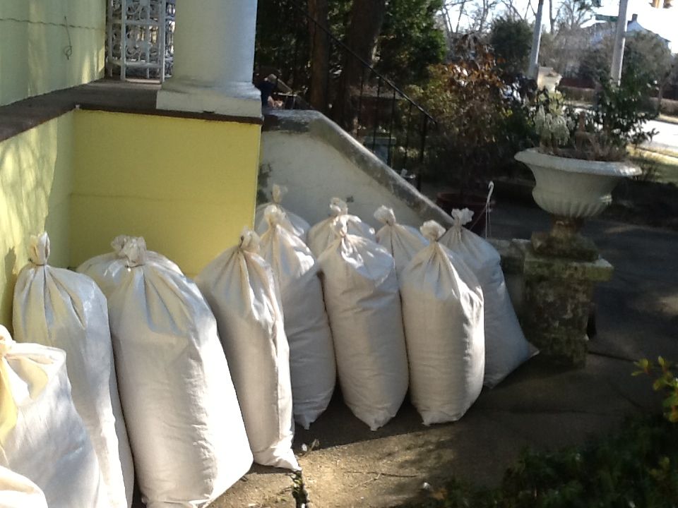 22 bags of shavings in the walkway viewed towards the front steps of the house