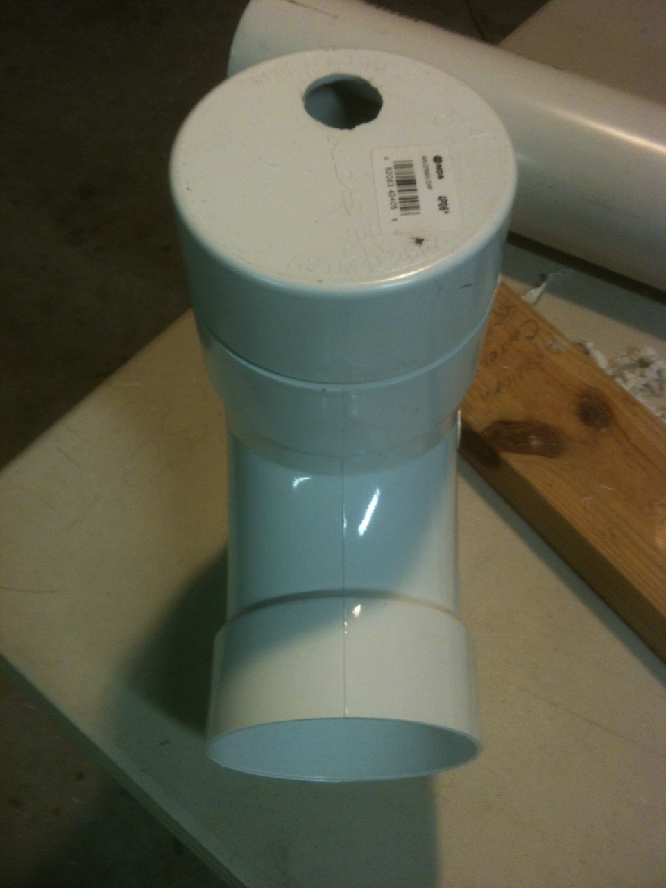 3. Glue end cap with 1" hole on bottom of tee with the hole opposite the of the sweep side of tee.