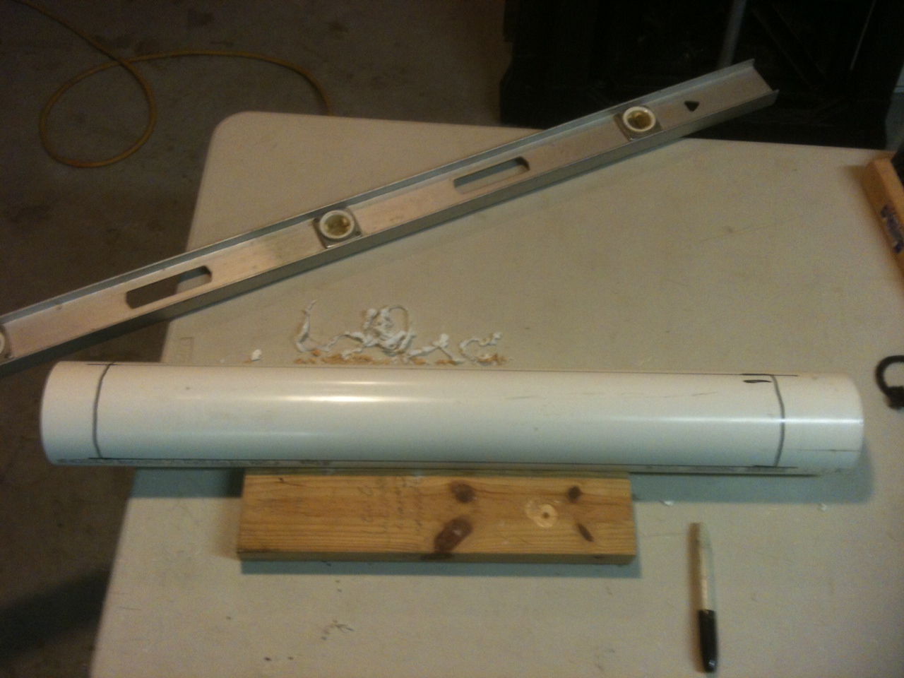 5. Mark out for your cut-out. (about 1/3 of the circumference of the pipe) leaving 2 or 3 inches on each end intact.