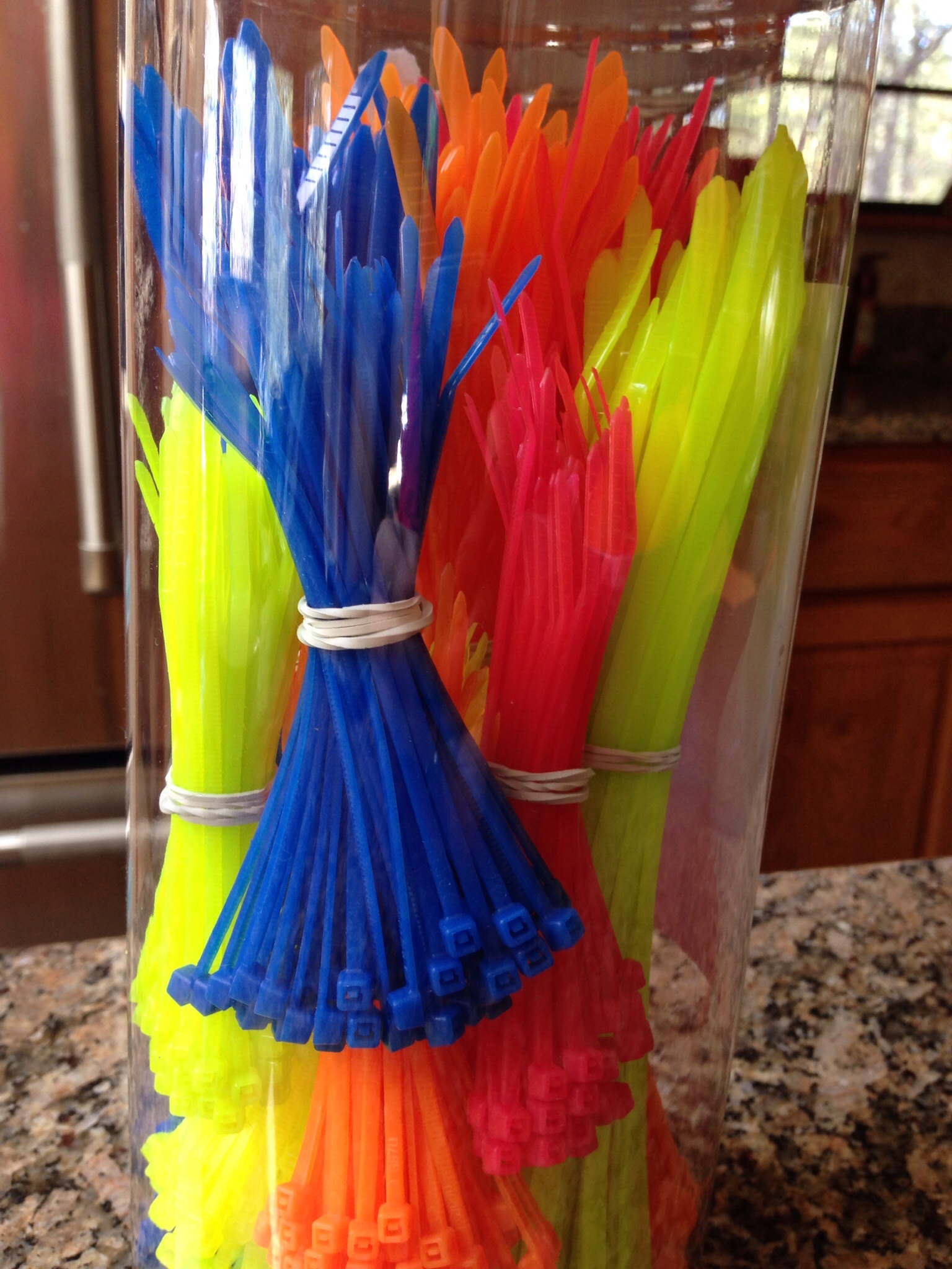 A bucket of zip ties of differing sizes in a variety of colors from Home Depot