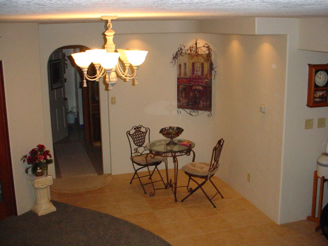A curved wall and soffit in the seating area at the bottom of the stair.