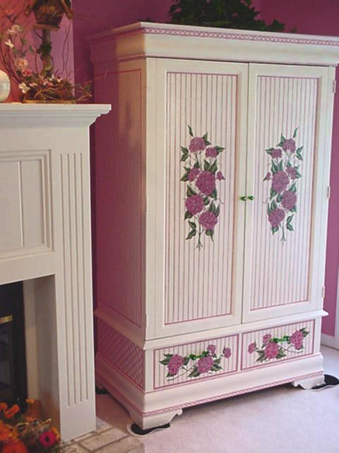 A custom painted entertainment cabinet commissioned by one of our remodel clients for her living room.