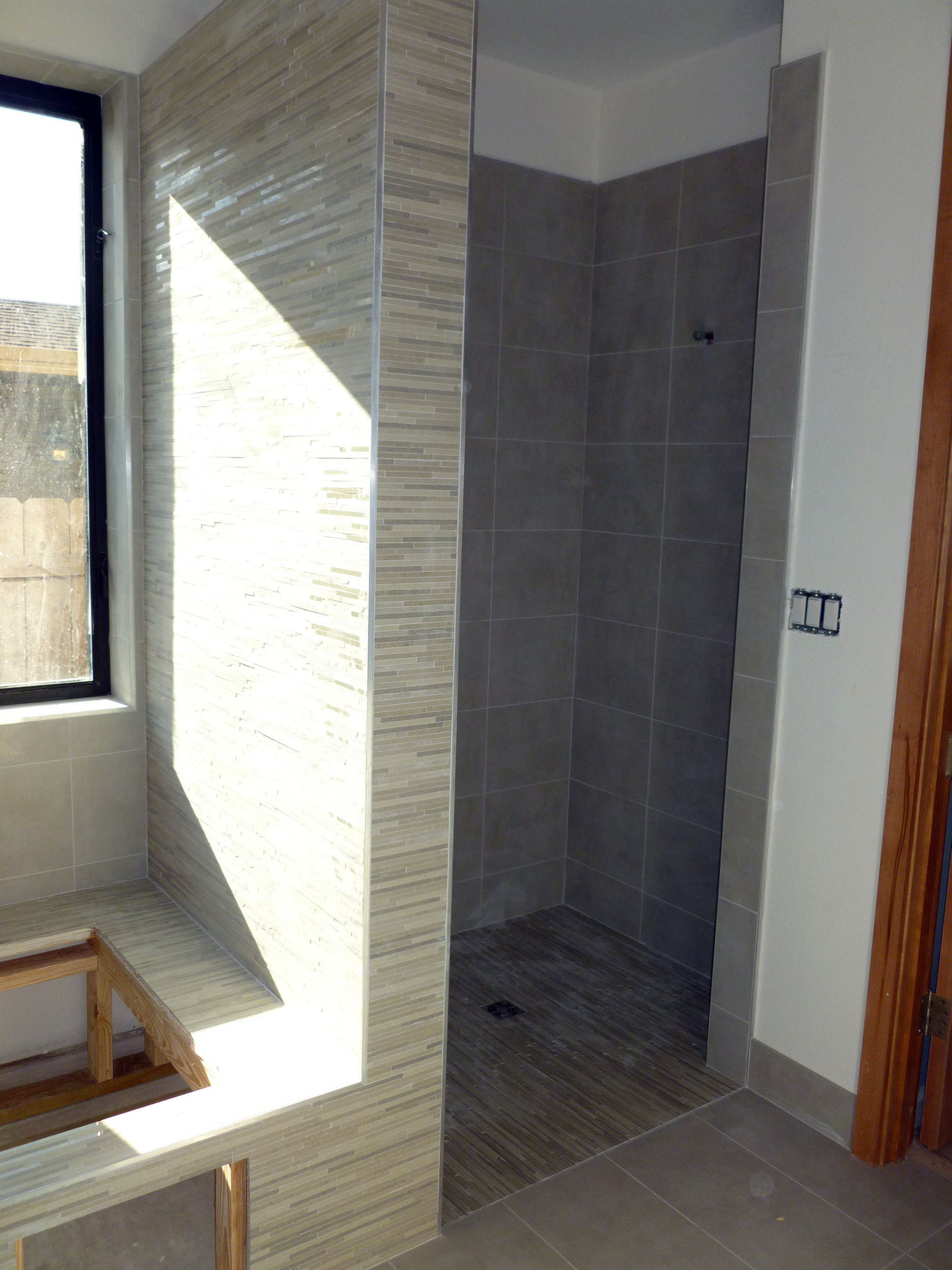 A shower and tub deck in a custom home.