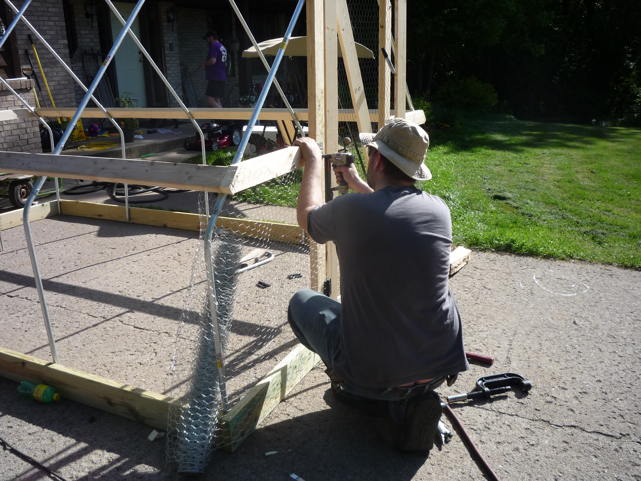 After frame was complete, we stapled on 36" poultry netting between the base and side purlins.
