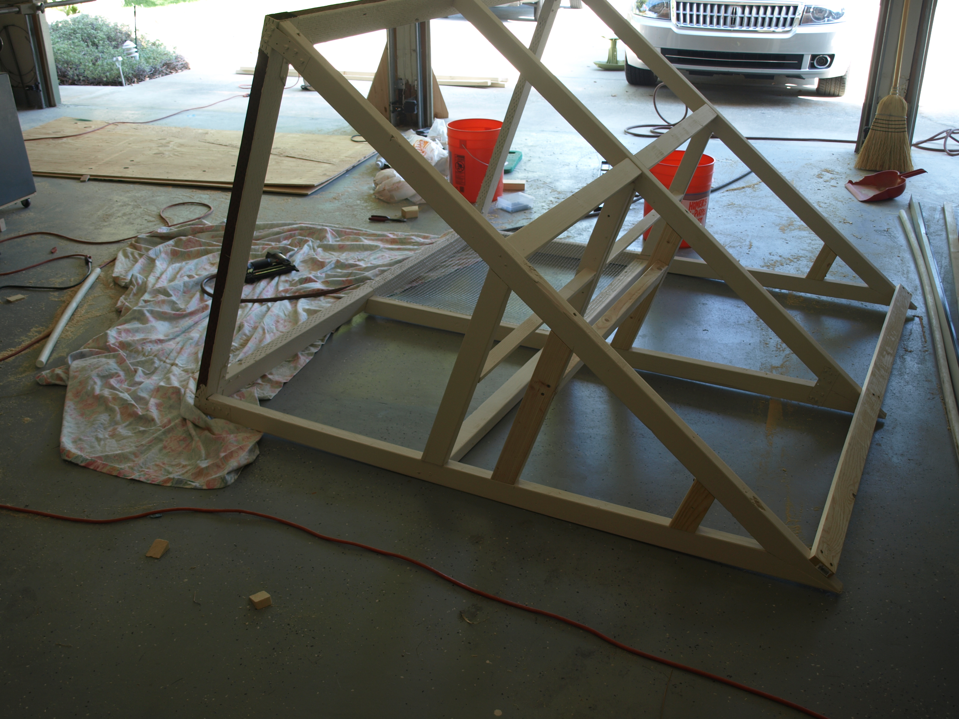 After struggling with putting in some hard cloth and hooks for feeders and such.  We finally got the brilliant idea to turn the coop on it's side.  Life became so much easier!  ; P