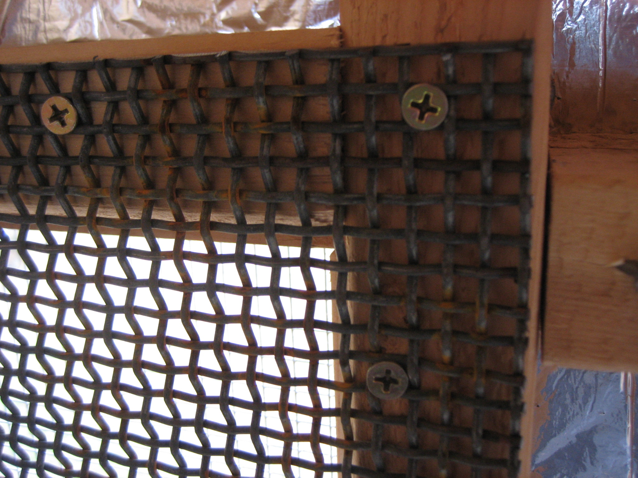 All of the shuttered windows and the Restore window are covered with this open diamond plate screening that we got from the salvage yard.  This is about as predator proof as we could get.