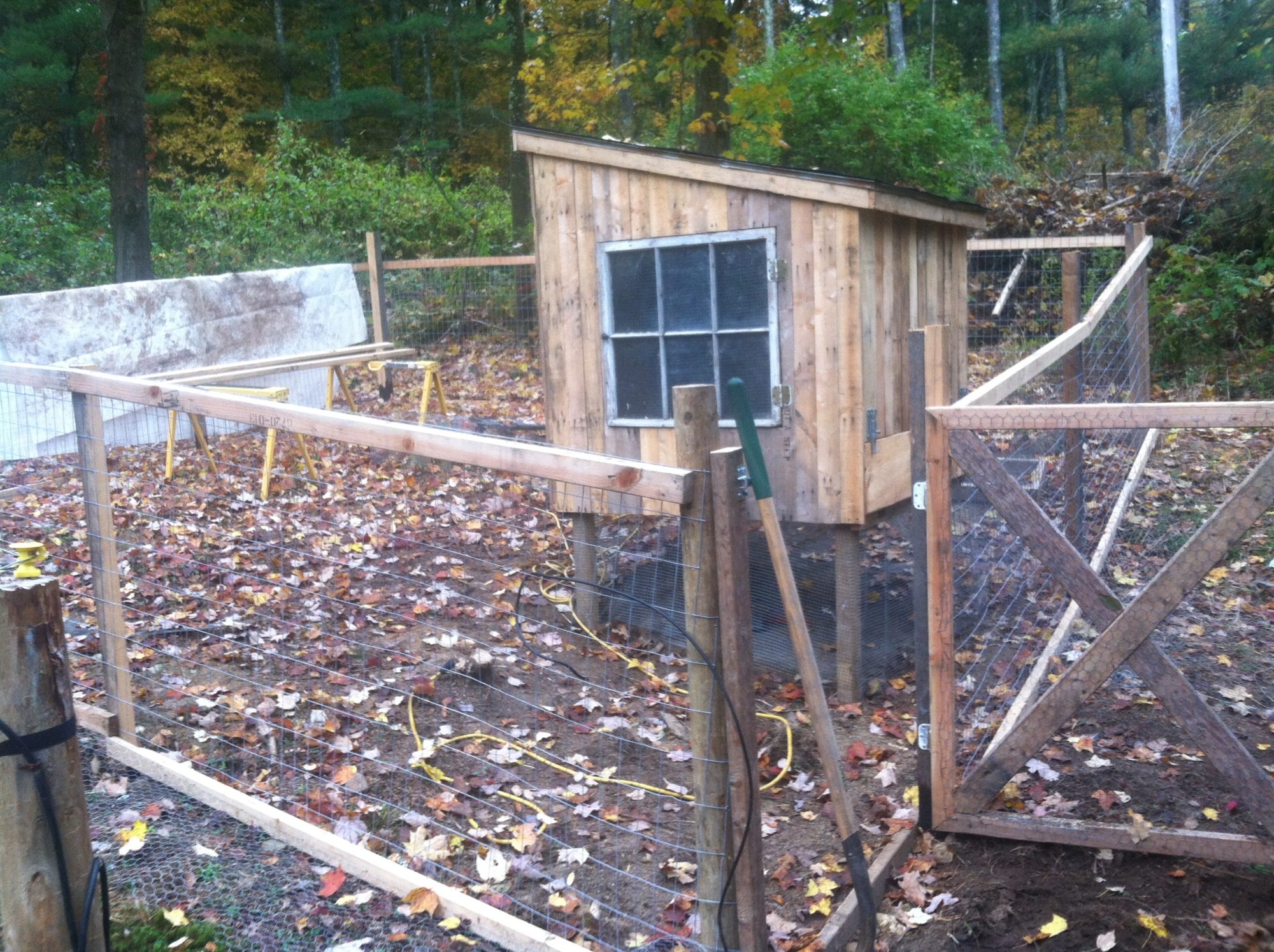 All the framework for the fence came from pallets that used to hold hot tubs, all 2x3s for free and I made the posts out of rough sawn pine and weatherproofed them.  The rolled asphalt roof was left over from an ice shanty I made.