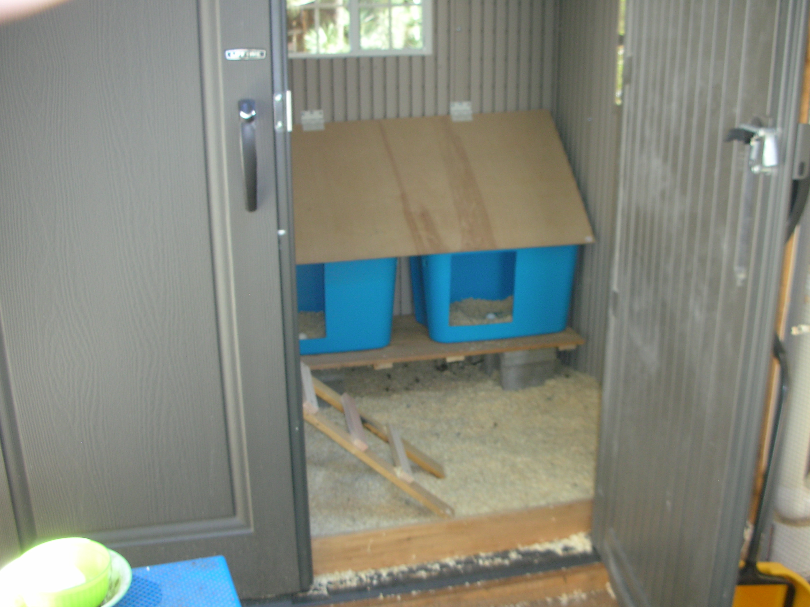 Another view of the nesting boxes looking in through the doorway. In this pic you'll see I added a 1" x 6" fence board so floor bedding doesn't constantly come out of the coop!