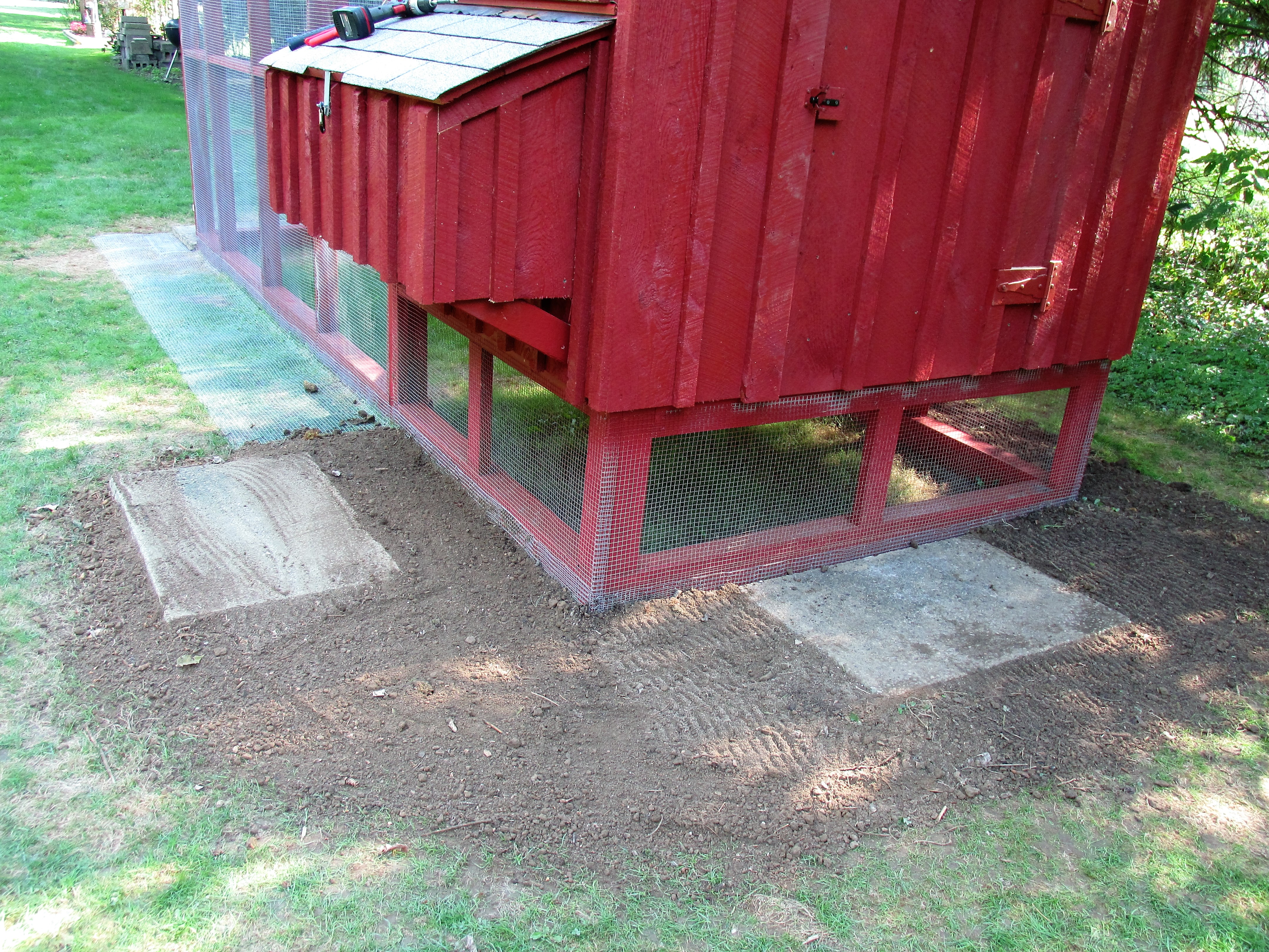 apron started covering it with dirt, and installed  cement slabs in front of doors and nesting box