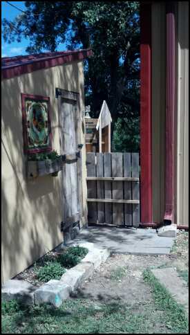 Area next to the flower bed will be a gravel walk-way that will eventually go all the way around the coop. Garden gate in made from a pallet I cut in half. Turned out pretty cute.