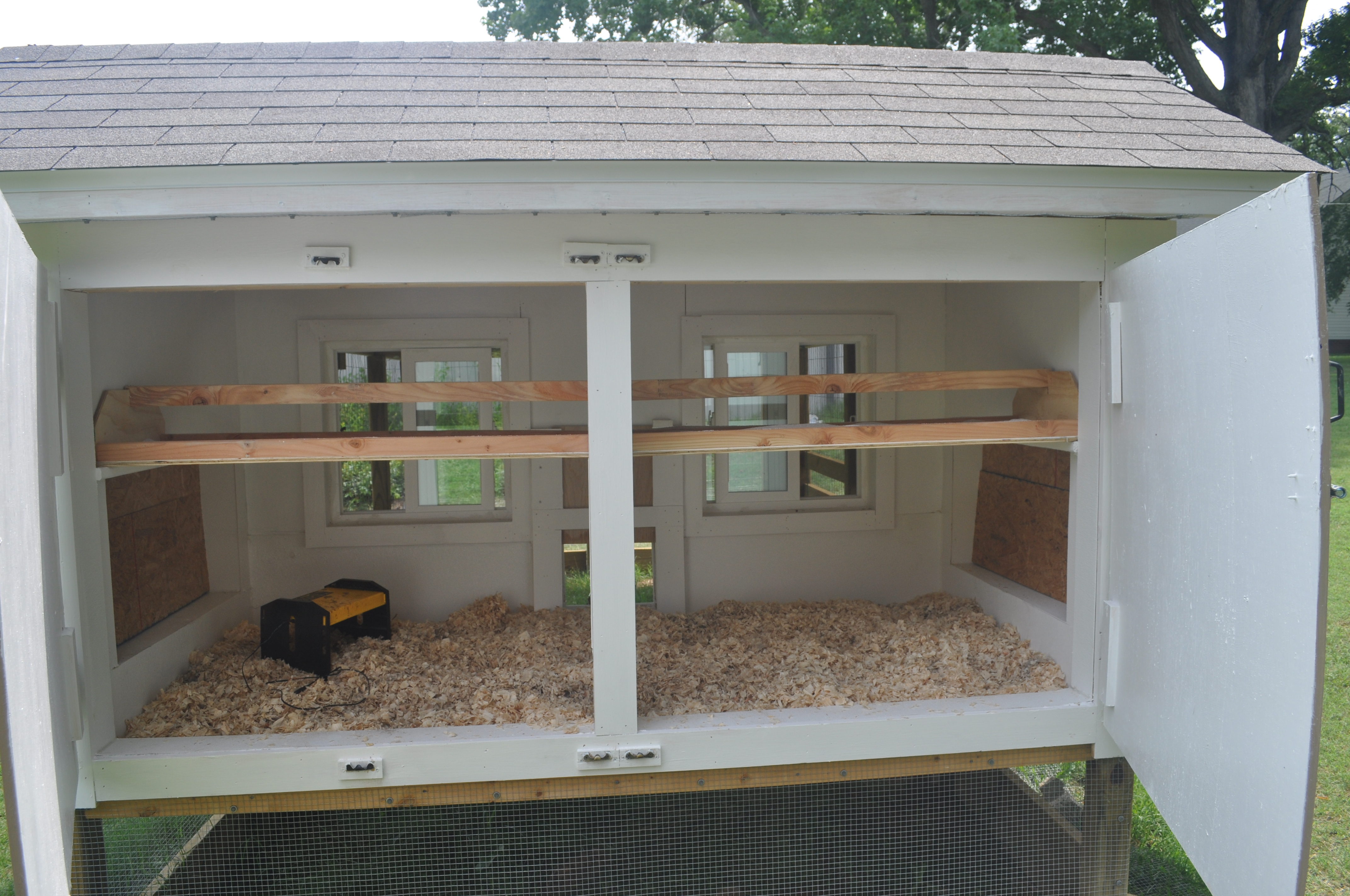 Back entry to the coop showing poop catching roosts