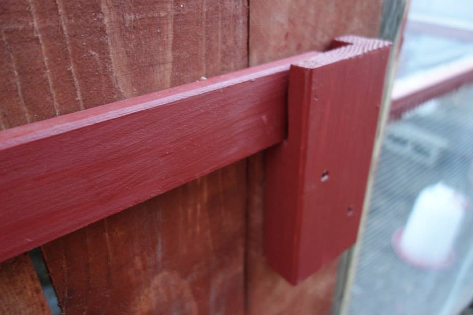 Big bar-type latch that secures the big double coop doors. Very secure and low-cost to make.