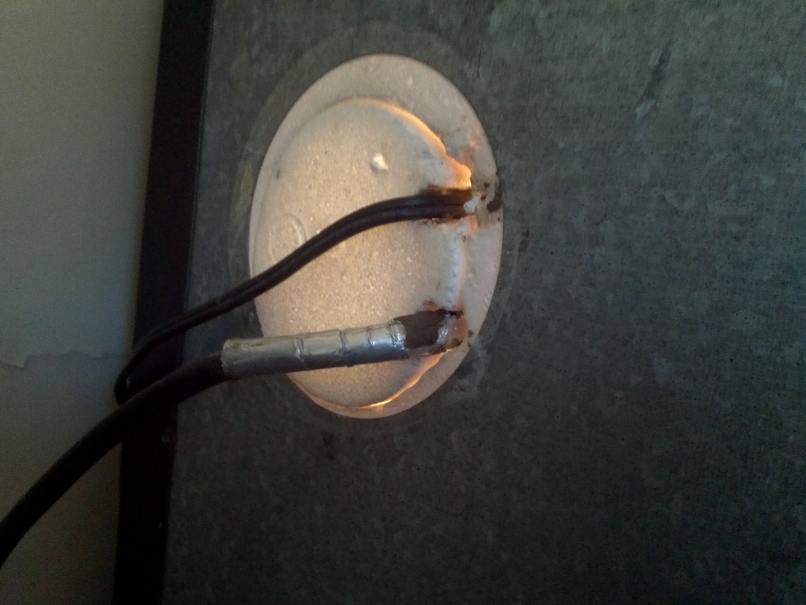 Both of the cords come out the back.