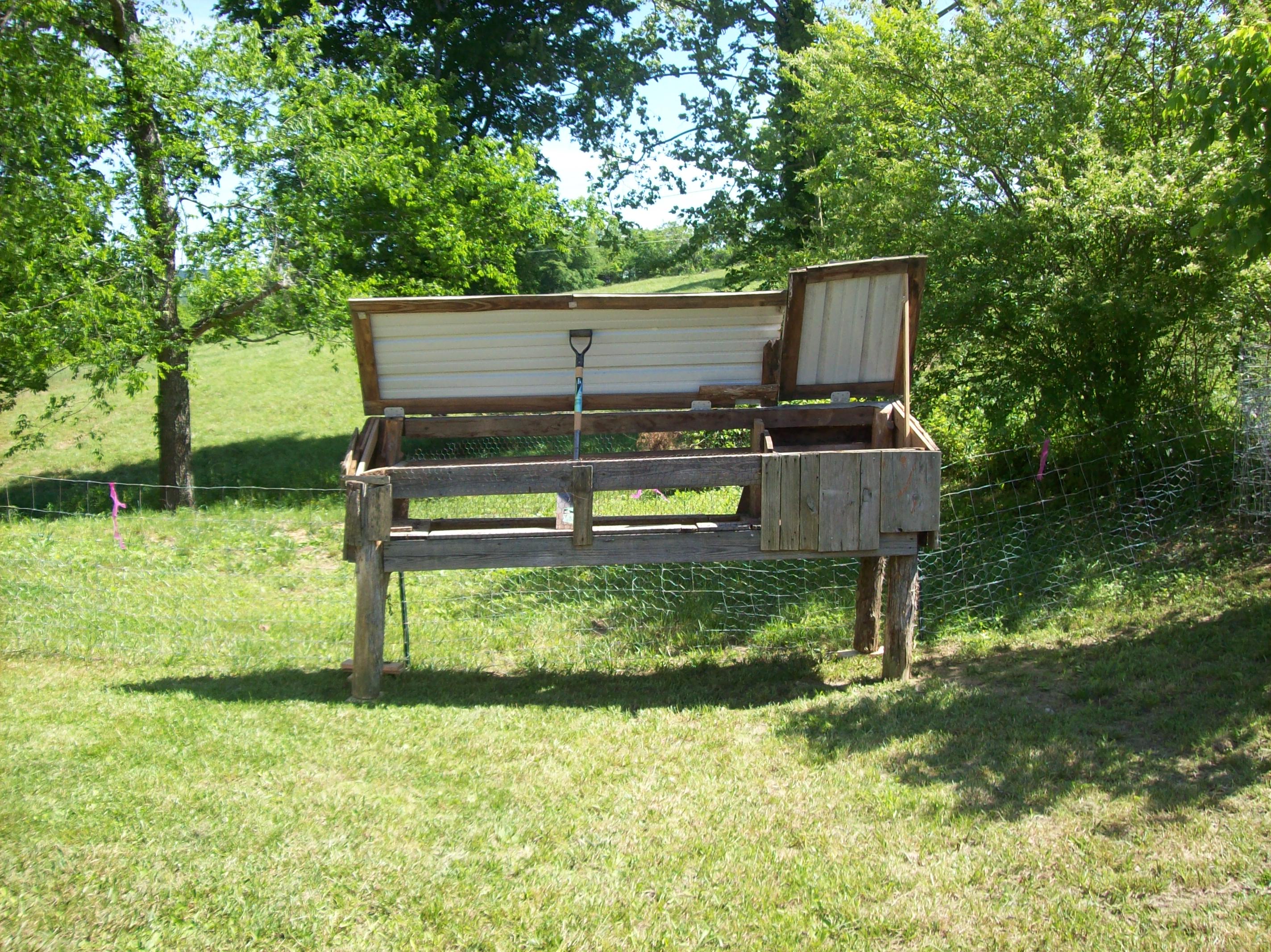 Brooder/Coop inside - gift from neighbor  5/25/13
I plan on enclosing the sides and bottom and putting in nesting boxes, with a ramp and opening into a run for the corner of the yard (will build soon).  And I need to move it over, off the slope. I have it propped open after cleaning it out (had some debris in it) and dry the wood.  The chicks will go here when they're old enough and then I'll turn it into a regular coop when they are older still. It's a start!